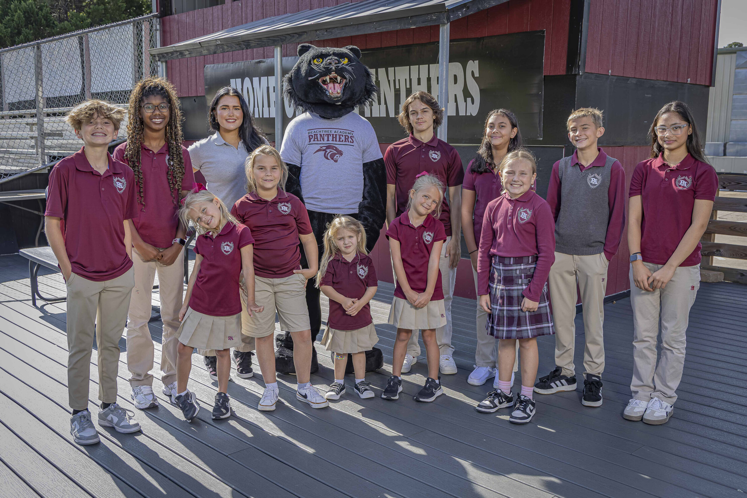 Peachtree Academy students wearing school uniforms with the Panther mascot